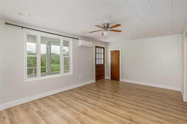 spare room with baseboards, light wood-style floors, ceiling fan, and a wall mounted air conditioner