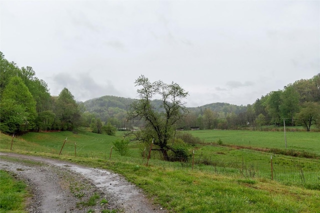 view of road featuring a view of trees, a mountain view, and a rural view