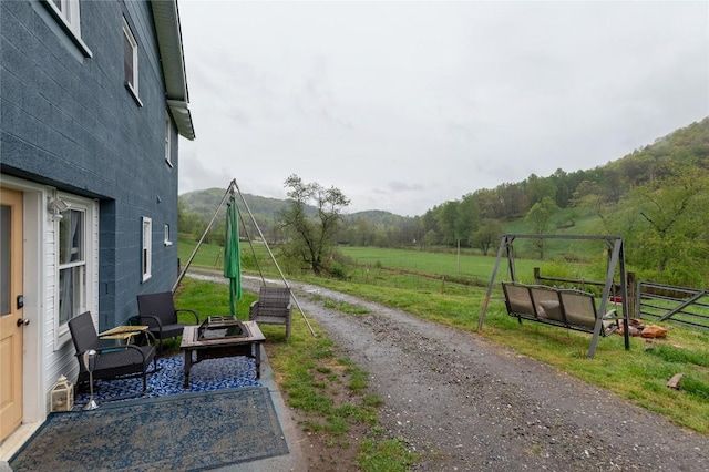 exterior space with a mountain view and fence