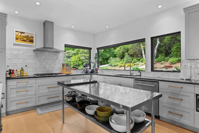 1240 King Gap Rd, Highlands, NC 28741 - kitchen with wall chimney exhaust hood, appliances with stainless steel finishes, recessed lighting, tasteful backsplash, and light wood-type flooring