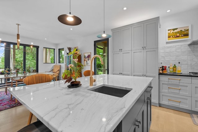 1240 King Gap Rd, Highlands, NC 28741 - kitchen with gray cabinetry, recessed lighting, pendant lighting, light stone countertops, and light wood finished floors