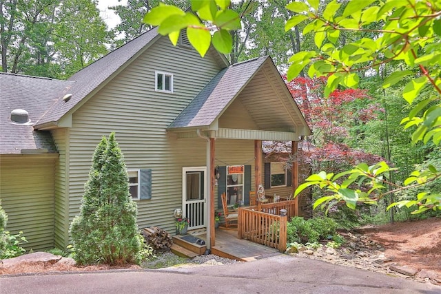 151 Rhododendron Ct, Sapphire, NC 28774 - view of front of house featuring a shingled roof and covered porch