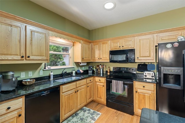 151 Rhododendron Ct, Sapphire, NC 28774 - kitchen with black appliances, light wood-style floors, and dark stone countertops