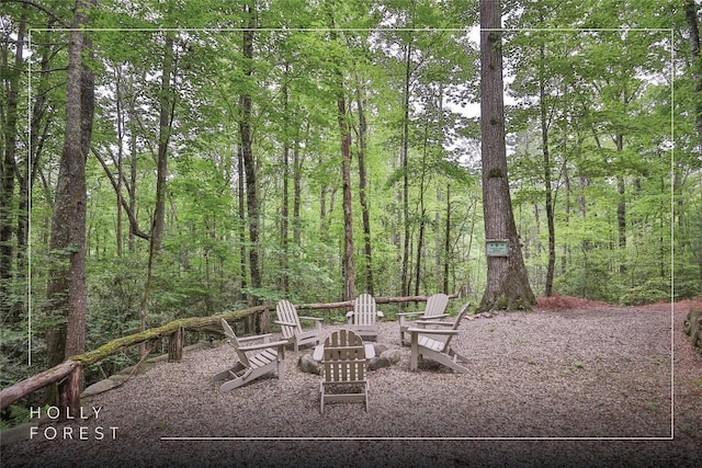 151 Rhododendron Ct, Sapphire, NC 28774 - view of patio / terrace featuring a fire pit and a wooded view