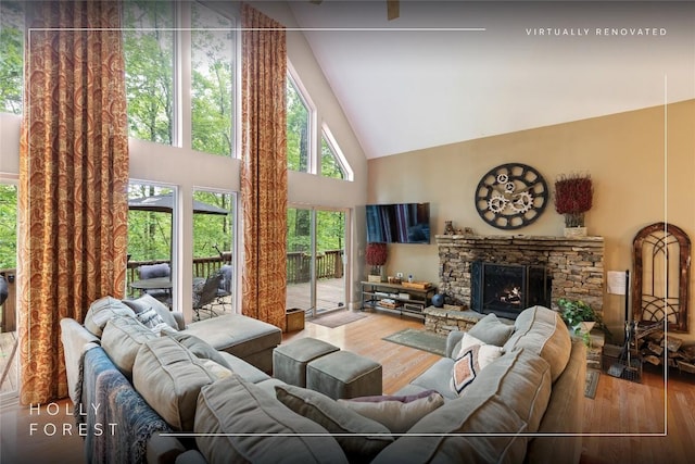 151 Rhododendron Ct, Sapphire, NC 28774 - living area featuring high vaulted ceiling, wood finished floors, and a stone fireplace