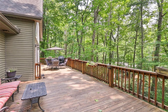151 Rhododendron Ct, Sapphire, NC 28774 - wooden terrace featuring outdoor dining area and a wooded view