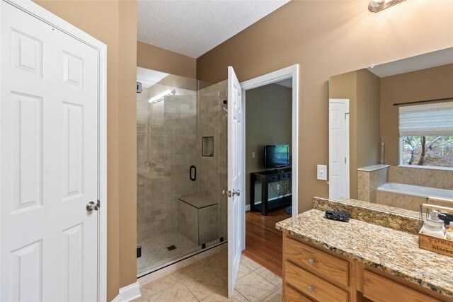 151 Rhododendron Ct, Sapphire, NC 28774 - bathroom featuring a stall shower, tile patterned flooring, a bath, and a textured ceiling