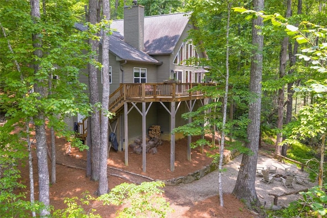 151 Rhododendron Ct, Sapphire, NC 28774 - back of property with a wooden deck, a chimney, and roof with shingles