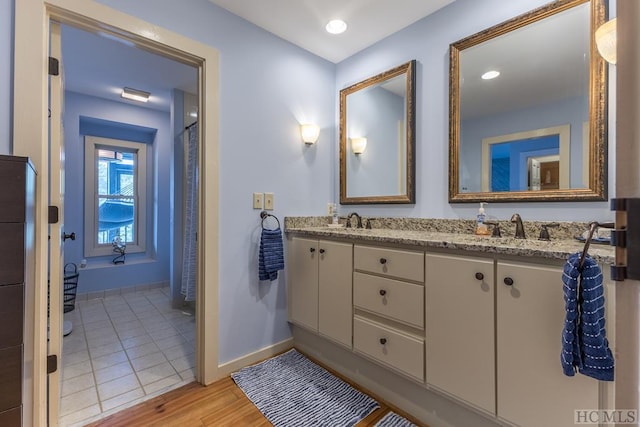 bathroom with vanity and wood-type flooring