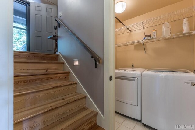 laundry area with light tile patterned flooring and separate washer and dryer