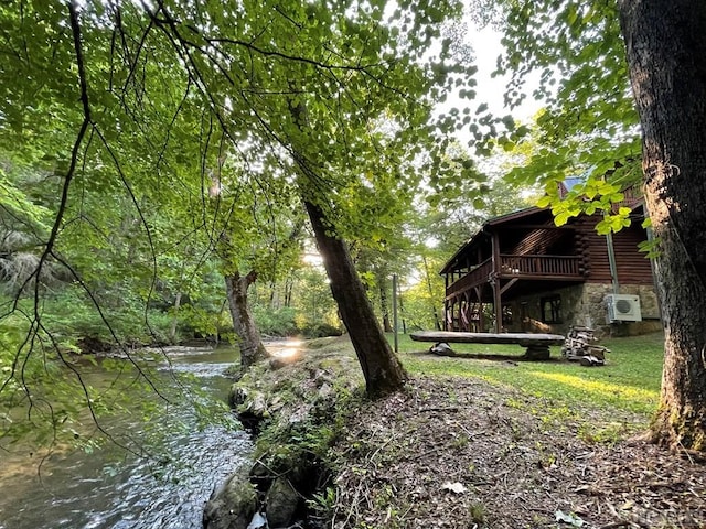 view of yard featuring a deck with water view