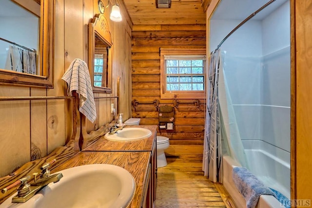 full bathroom with shower / tub combo, log walls, hardwood / wood-style floors, wooden ceiling, and toilet