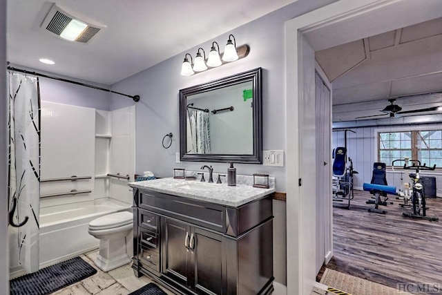 full bathroom with ceiling fan, toilet, vanity, and shower / bathtub combination with curtain