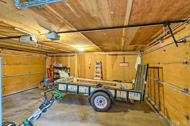 garage featuring a garage door opener and wood ceiling