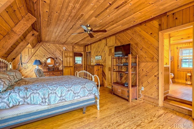 bedroom featuring light hardwood / wood-style flooring, ceiling fan, wood ceiling, ensuite bath, and lofted ceiling