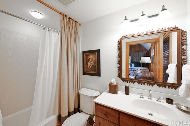 full bathroom with vanity, shower / tub combo, and toilet