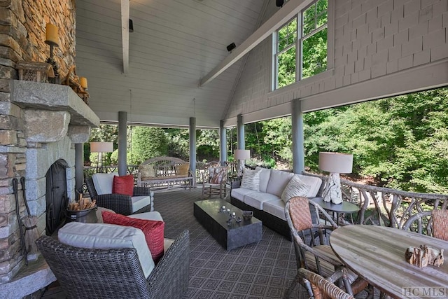 view of patio with an outdoor living space with a fireplace