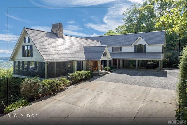 view of front of house with a carport and a sunroom