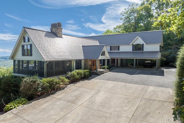 view of front of house with a carport and a sunroom