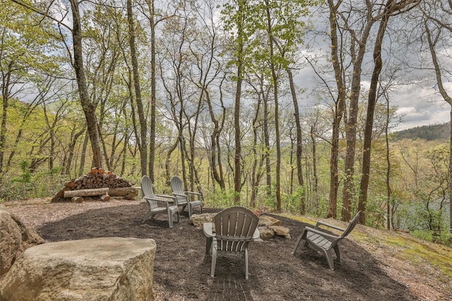 572 Mane St, Glenville, NC 28736 - view of patio / terrace featuring a fire pit and a wooded view