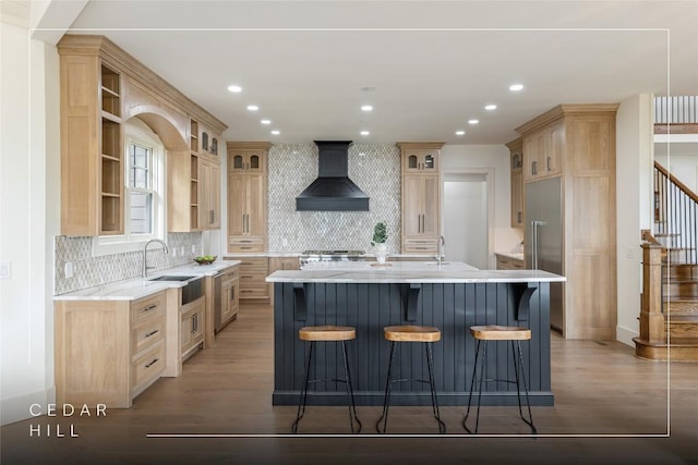 343 Ledgeview Rd, Cashiers, NC 28717 - kitchen with custom range hood, light brown cabinets, an island with sink, wood finished floors, and open shelves