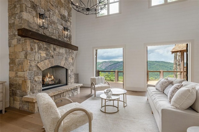 343 Ledgeview Rd, Cashiers, NC 28717 - living room featuring a high ceiling, a chandelier, wood finished floors, a fireplace, and a mountain view