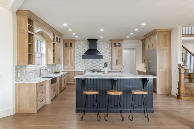 343 Ledgeview Rd, Cashiers, NC 28717 - kitchen featuring custom range hood, light brown cabinetry, an island with sink, open shelves, and light wood-style floors
