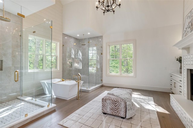 343 Ledgeview Rd, Cashiers, NC 28717 - full bath with plenty of natural light, a freestanding bath, a shower stall, wood finished floors, and a towering ceiling