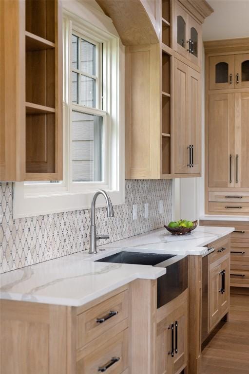 343 Ledgeview Rd, Cashiers, NC 28717 - kitchen with open shelves, tasteful backsplash, glass insert cabinets, light stone counters, and light brown cabinets