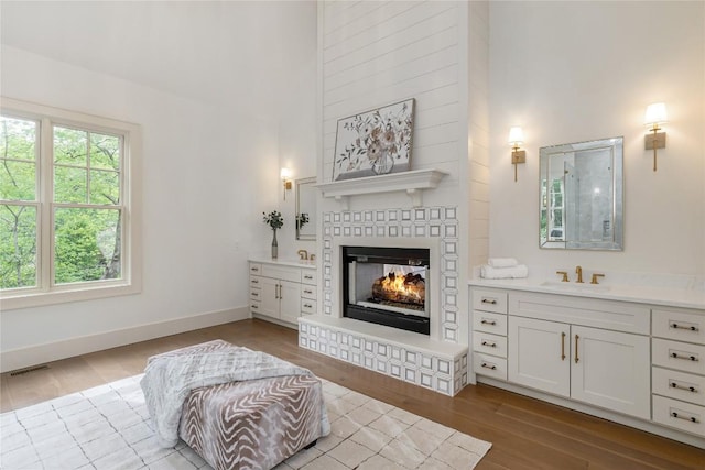 343 Ledgeview Rd, Cashiers, NC 28717 - living room featuring a high ceiling, a glass covered fireplace, and wood finished floors