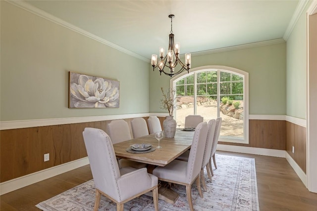 343 Ledgeview Rd, Cashiers, NC 28717 - dining area featuring a chandelier, ornamental molding, wood finished floors, a wainscoted wall, and wooden walls