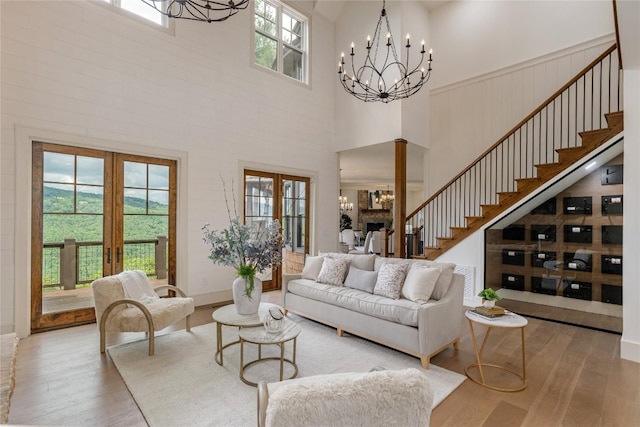343 Ledgeview Rd, Cashiers, NC 28717 - living area with a chandelier, a high ceiling, wood finished floors, french doors, and stairs