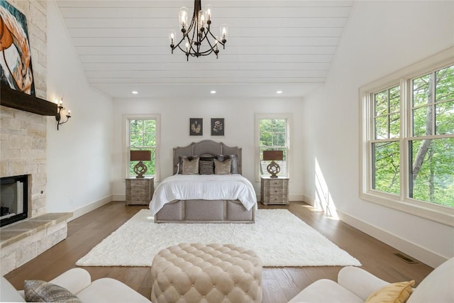 343 Ledgeview Rd, Cashiers, NC 28717 - bedroom featuring lofted ceiling, a chandelier, a fireplace, wood finished floors, and recessed lighting