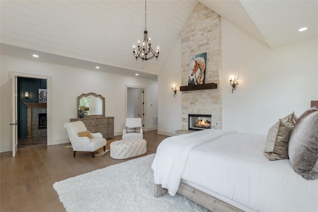 343 Ledgeview Rd, Cashiers, NC 28717 - bedroom with a multi sided fireplace, a chandelier, wood finished floors, high vaulted ceiling, and recessed lighting