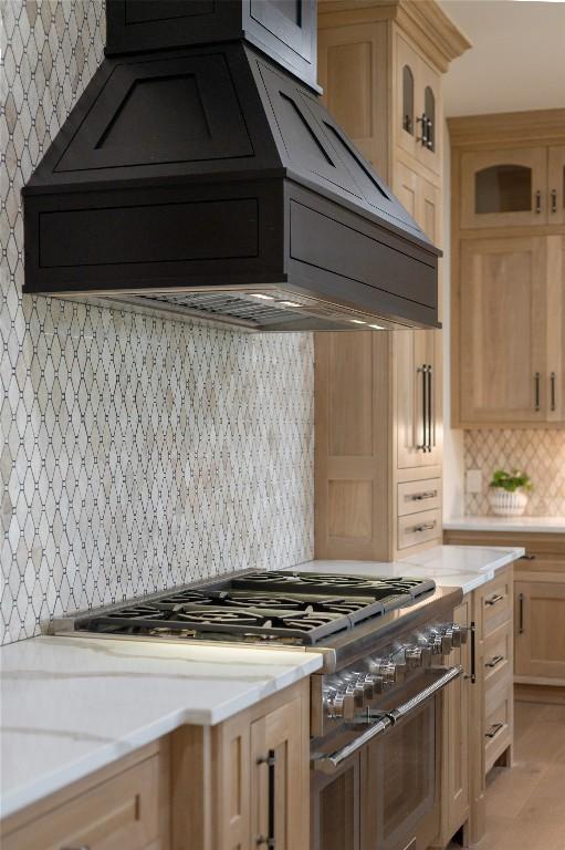 343 Ledgeview Rd, Cashiers, NC 28717 - kitchen featuring double oven range, tasteful backsplash, glass insert cabinets, custom range hood, and light brown cabinets