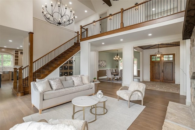 343 Ledgeview Rd, Cashiers, NC 28717 - living room with a chandelier, a towering ceiling, wood finished floors, stairway, and recessed lighting