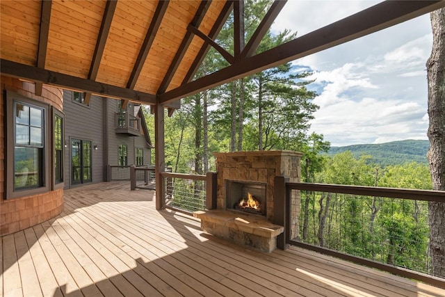 343 Ledgeview Rd, Cashiers, NC 28717 - deck featuring an outdoor stone fireplace and a view of trees