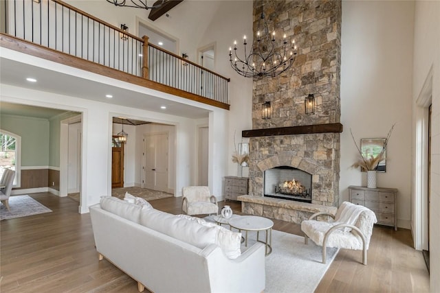 343 Ledgeview Rd, Cashiers, NC 28717 - living room featuring a chandelier, a high ceiling, wood finished floors, and a fireplace
