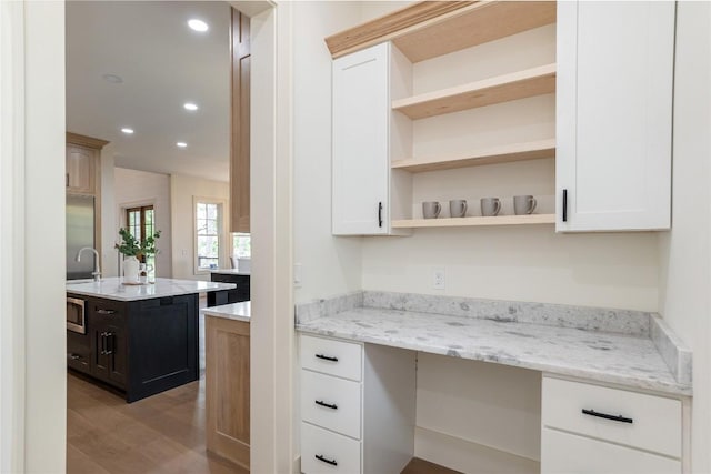343 Ledgeview Rd, Cashiers, NC 28717 - kitchen with built in desk, light wood-type flooring, open shelves, recessed lighting, and white cabinets