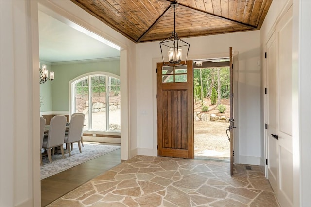 343 Ledgeview Rd, Cashiers, NC 28717 - foyer entrance featuring wood ceiling, a chandelier, stone finish floors, and ornamental molding