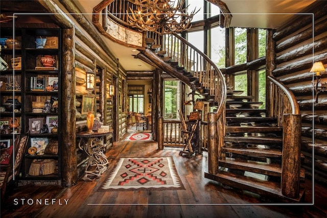 1090 Zeb Alley Rd, Cashiers, NC 28717 - stairway featuring hardwood / wood-style flooring, a chandelier, and a towering ceiling