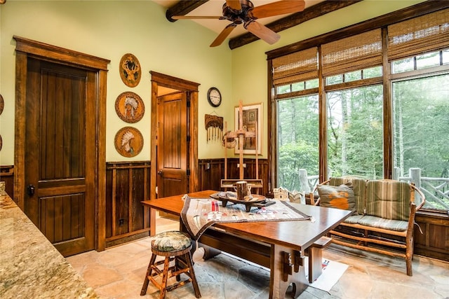 1090 Zeb Alley Rd, Cashiers, NC 28717 - dining space with a wainscoted wall, light stone finish flooring, a ceiling fan, plenty of natural light, and wooden walls