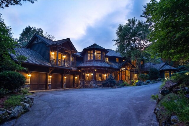 1090 Zeb Alley Rd, Cashiers, NC 28717 - view of front of house featuring a balcony, driveway, and an attached garage