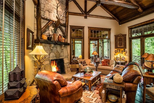 1090 Zeb Alley Rd, Cashiers, NC 28717 - living room with a wooden ceiling with exposed beams, a stone fireplace, and high vaulted ceiling