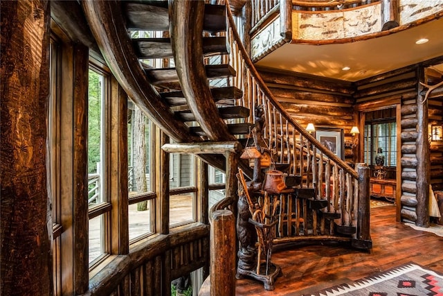 1090 Zeb Alley Rd, Cashiers, NC 28717 - staircase featuring log walls, hardwood / wood-style flooring, and recessed lighting