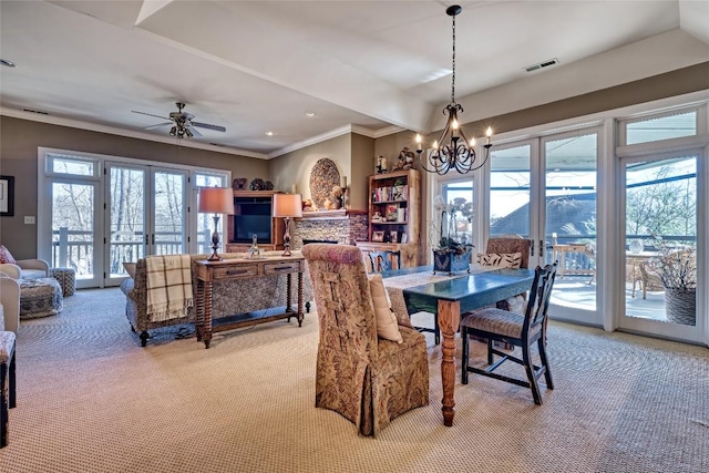 dining area featuring visible vents, french doors, light carpet, crown molding, and ceiling fan with notable chandelier