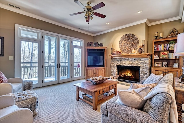 living room featuring french doors, plenty of natural light, a fireplace, and a ceiling fan