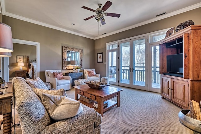 living room with light colored carpet, french doors, crown molding, and a ceiling fan