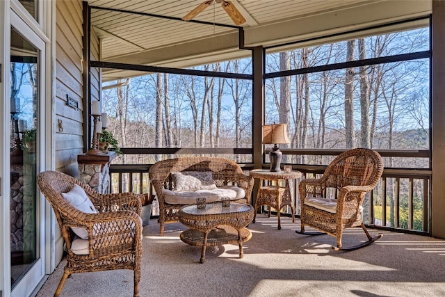 sunroom / solarium with a wealth of natural light and ceiling fan