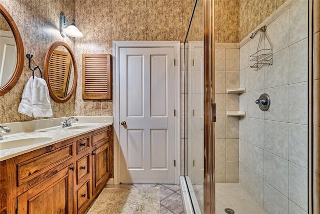 bathroom featuring tile patterned floors, a stall shower, double vanity, and a sink